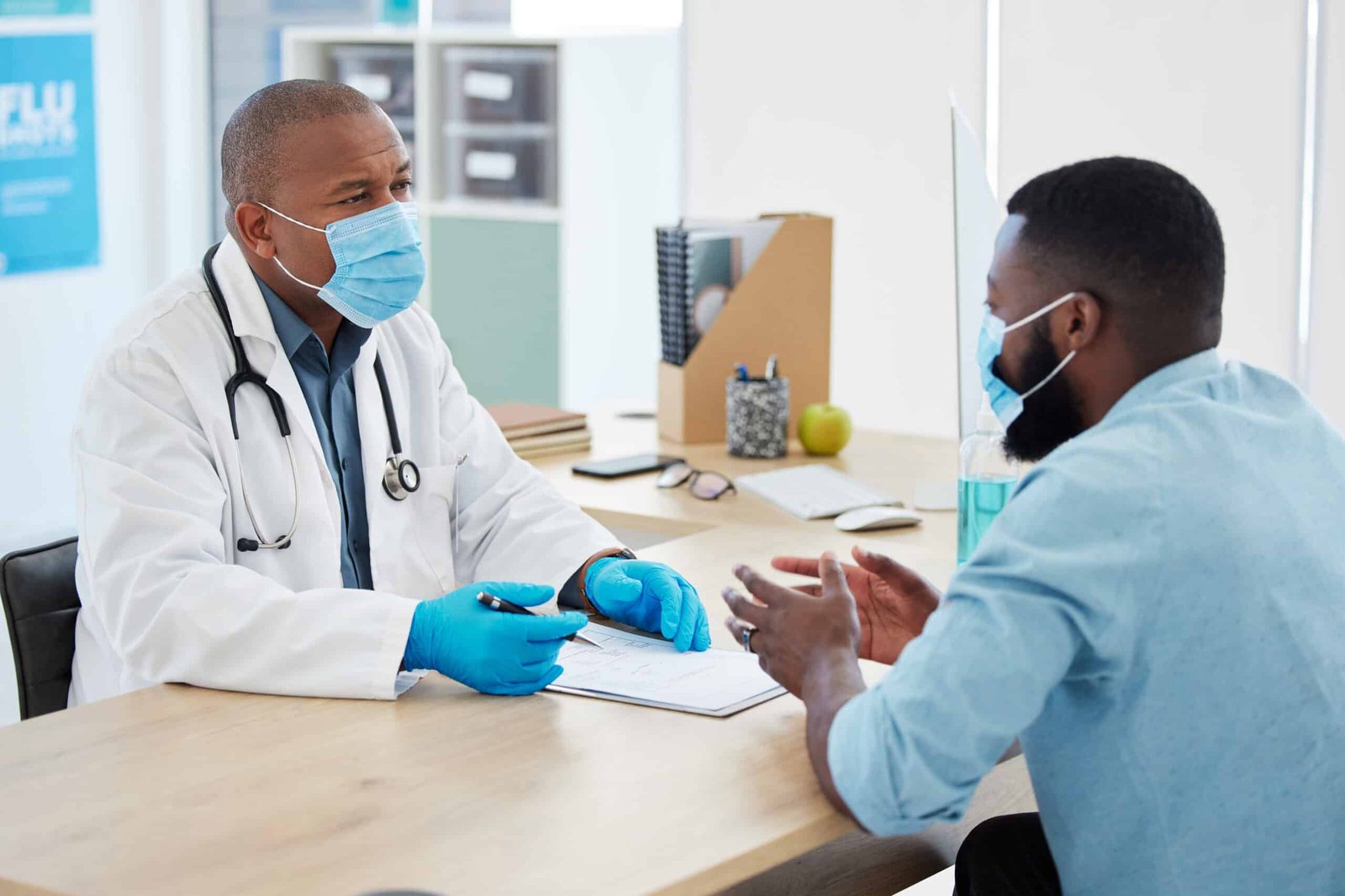 African american doctor talking a patient about his results. Patient in a checkup with a doctor. De